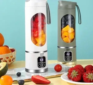 Two portable fruit juice makers on a table with fruits around